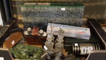 A box containing a selection of interesting items including a desk calendar, twin whiskey glass etc