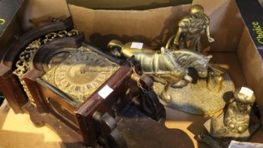 A box containing a heavy brass model of a blacksmith a wall clock and others