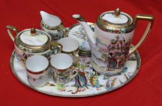 A Noritake porcelain coffee set on oval tray, Oriental design gilded