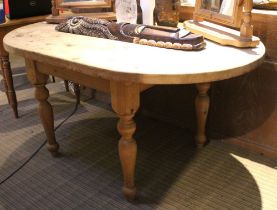 An oval substantial pine kitchen table with removal legs