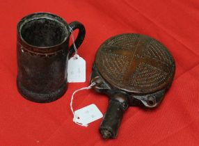 An 18th century leather tankard with white metal band 11cm high, together with a 19th chip carved an