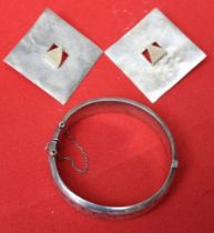 A pair of silver designer earrings of square form with mesh triangles to the centres, together with