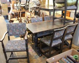 An oak dining set, consisting of a set of six upholstered chairs including two carvers and a tavern