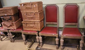 A set of six carved oak chairs with red leather backs and seats to include two carvers