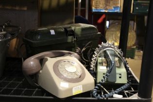 Two vintage telephones with a military field telephone