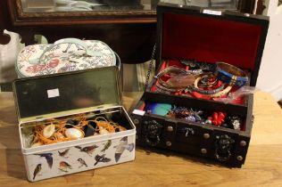 A wooden jewellery box, a bag and a tin containing a good selection of costume jewellery