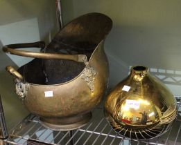 A brass coal bucket with a golden vase