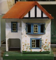 A small wooden dolls house in the form of a 1930's style town house. 42 cm in height