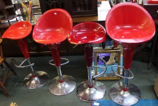 Four red plastic bar stools with chrome stand and adjustable base, one a/f