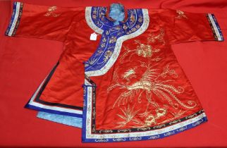 A Chinese embroidered red silk jacket