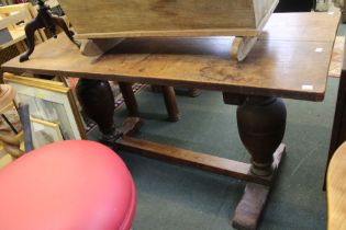 An oak refectory dining table raised on turned end supports