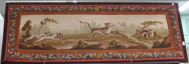 A 17th Century French tapestry panel depicting a pair of hounds to the left chasing a central leopar