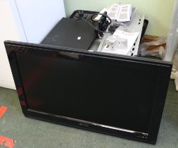 A Philips flat screen television with wall mounting and stand with a signal booster and an electroni