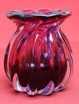 A Bohemian cranberry glass vase of fluted form, bears paper label 12.5cm high
