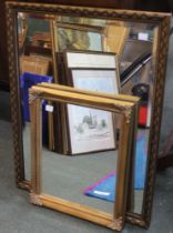 A bevelled edged gilt framed wall mirror together with another smaller example