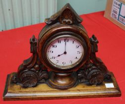 A Black Forest style decorative carved wood framed mantel clock. c.1900