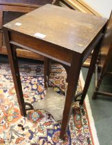 A small oak square occasional table with under tier