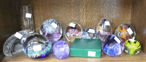 A shelf of twelve Glass Paperweights Caithness etc