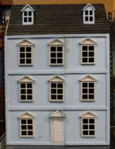 A large dolls house in the form of a Georgian town house 88 cm in height x 62 x 38