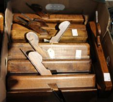 A box containing 7 Victorian wooden moulding planes and a selection of spare blades