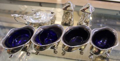 An Edwardian silver condiment set, comprising four salts, a lidded mustard pot and pair of pepper po