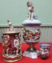 Three pieces of Continental moulded majolica ceramics, includes a lidded vase , a lidded tankard and