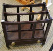 A modern dark wood Canterbury style magazine rack