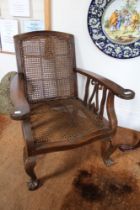 A Far Eastern, probably Burmese, plantation style bergere armchair with ball & claw feet