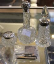 A quantity of silver and silver mounted glass items, comprising a vesta, scent bottles, tooth pick a