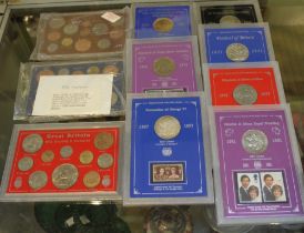 A collection of clip cased coin sets, includes coin/stamp sets, "Festival of Britain 1951", "Sir Win