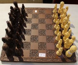 A modern resin figural chess set and board