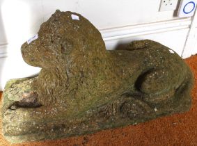 A pair of well weathered recumbent cast lions