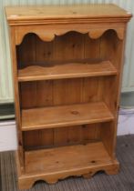 A small modern pine three shelf book case