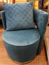 A turquoise upholstered modern revolving tub chair button back