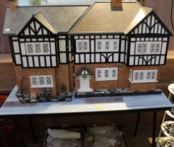 A large well made Dolls House together with an extensive collection of furniture etc (2 boxes)