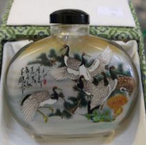 A large oval Chinese inside painted scent bottle, decorated with cranes & exotic birds