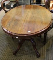A Victorian mahogany oval lou table, with snap top action, raised on turned stem with four cast su
