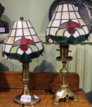 Two brass candlesticks converted to table lights, one being of Gothic Revival design, both with Tiff