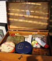 A large wooden box containing a wide selection of fly fishing tackle