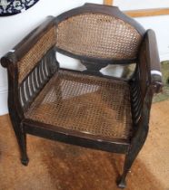 An Asian hardwood bergere seated occasional armchair, with roll top arms, probable Burmese