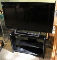 A JVC 40" flatscreen television, together with TV stand