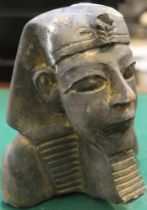 Ancient chiselled stone sculptured bust of an Egyptian Pharaoh still with traces of gold showing