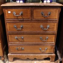 A reproduction mahogany two over three chest of drawers