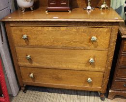 An oak three drawer chest on castors