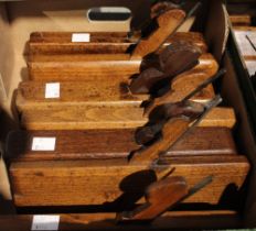 A box containing 8 Victorian wooden moulding planes