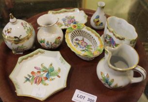 A collection of eight Herend porcelain items, including a lidded pot, basket weave item, cream jug e