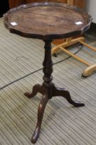 A dish topped tripod wine table