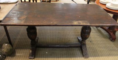 An Elizabethan design oak refectory table, raised on cup & cover trestle ends, 81cm x 152cm