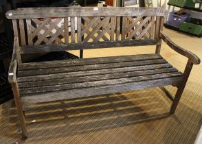 A slatted garden bench with lattice back