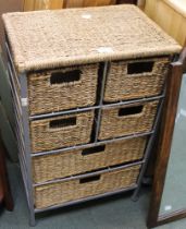 A metal framed unit containing wicker drawers